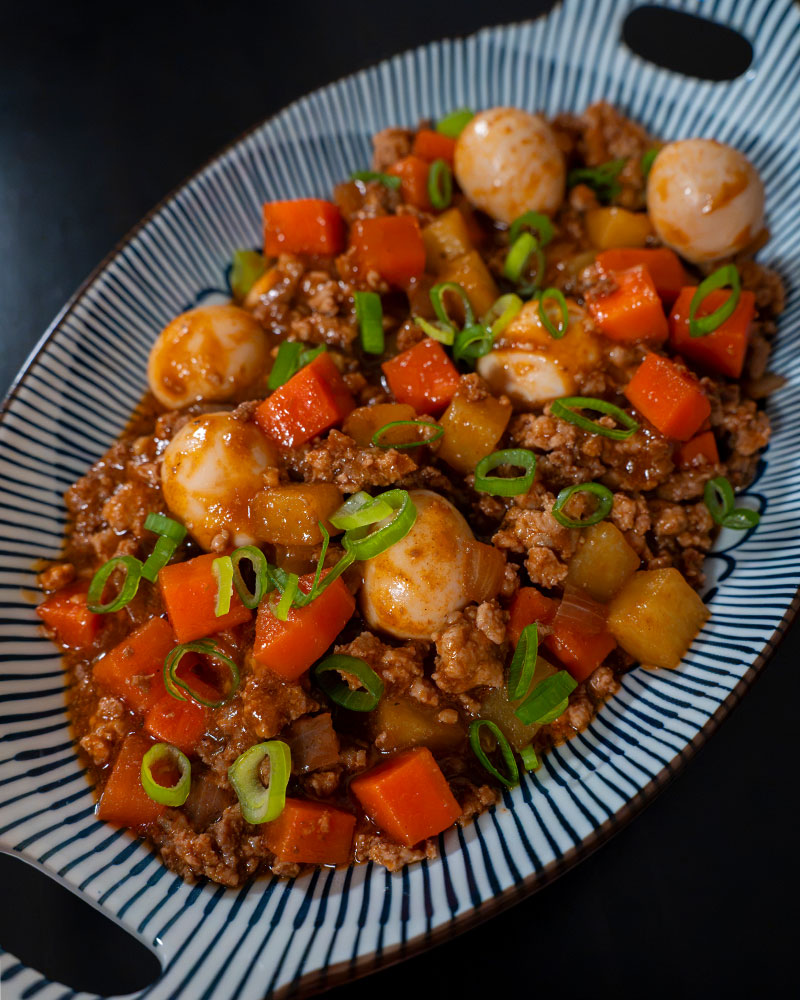 Giniling with ground pork, potatoes, carrots, and quail eggs garnished with scallions