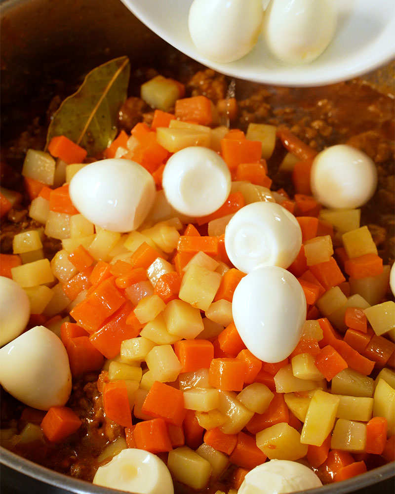 Cooked quail eggs added to Giniling with potatoes and carrots