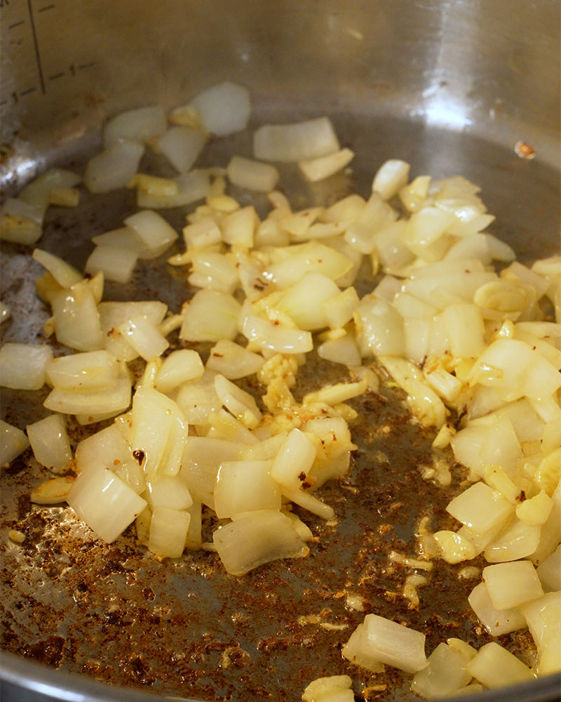 Sauteed garlic and onion in a pan for Giniling